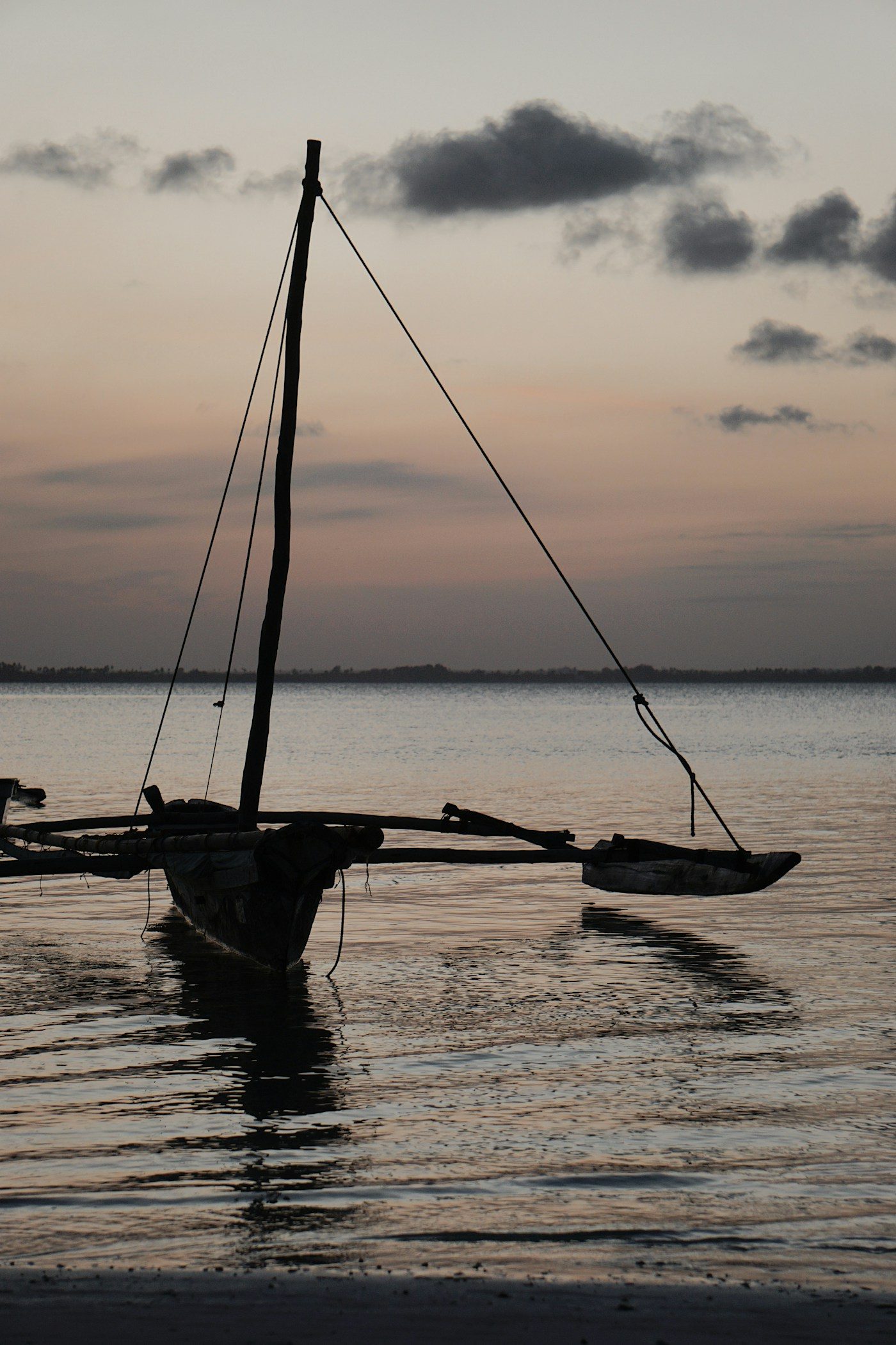 A dhow silhouetted against the setting sun