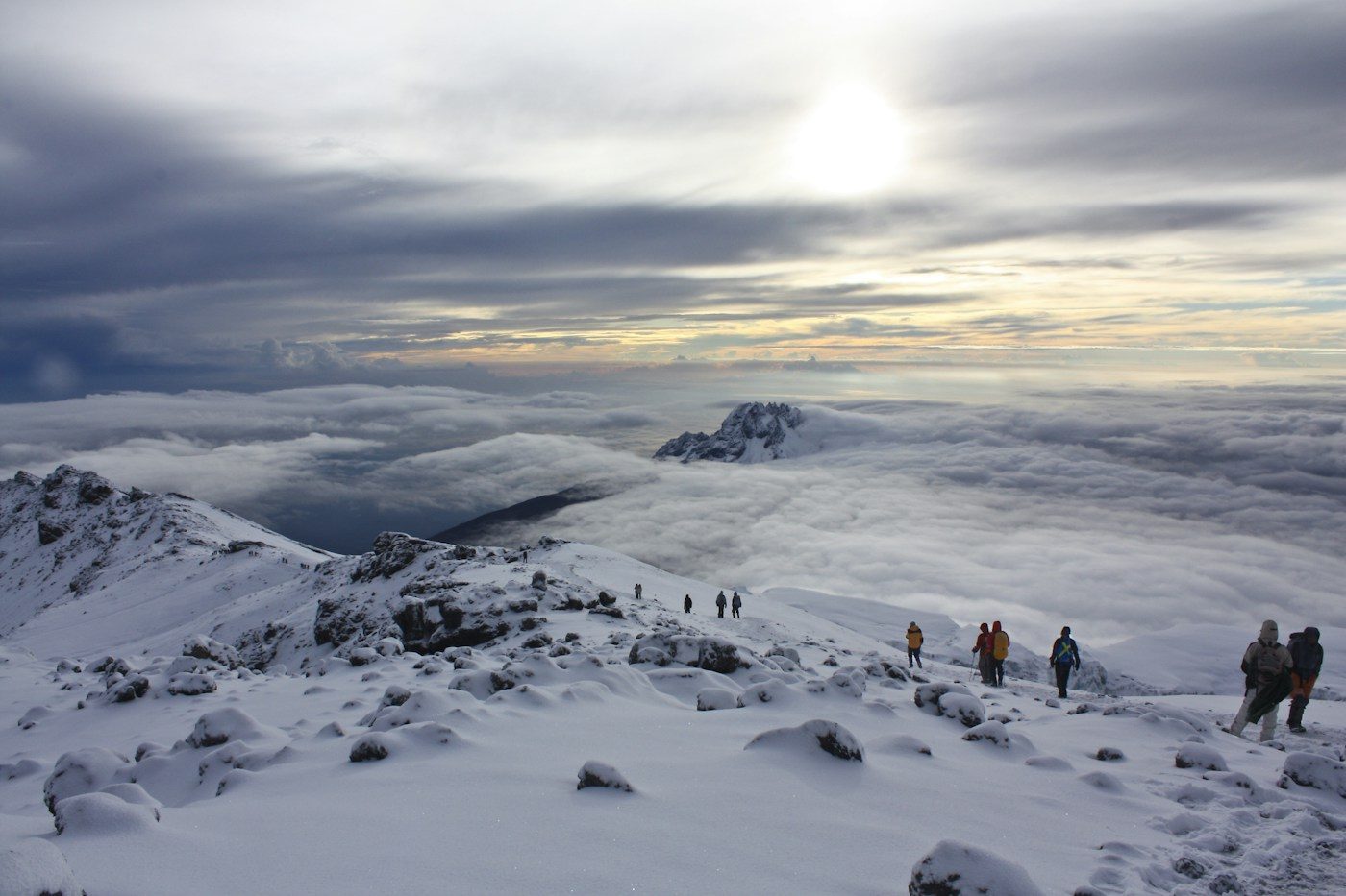 Climbers crossing the snow-covered crater rim of Kilimanjaro