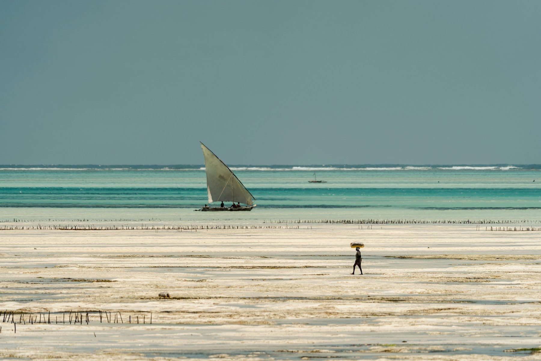 A dhow anchored in bright turquoise water